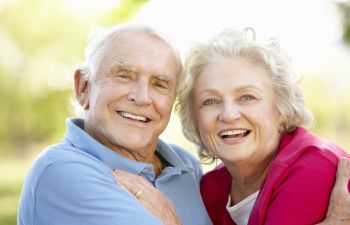 Happy elderly couple with perfect smiles.