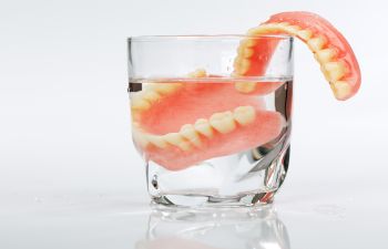 Set of Dentures in Glass of Water